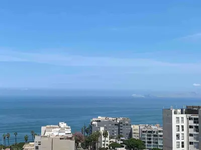 a view of the ocean from a city with buildings at Lovely Aparment OceanView Barranco1809 in Lima