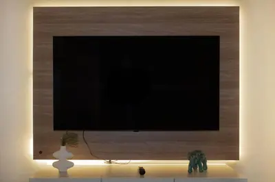 a flat screen tv on a wall with a vase at Lovely Aparment OceanView Barranco1809 in Lima