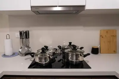 three pots and pans on a stove in a kitchen at Lovely Aparment OceanView Barranco1809 in Lima