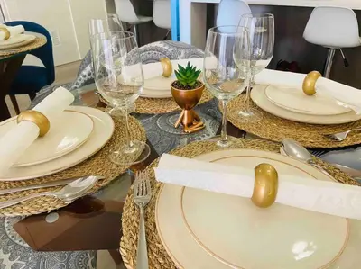 a table with plates and wine glasses on it at Lovely Aparment OceanView Barranco1809 in Lima