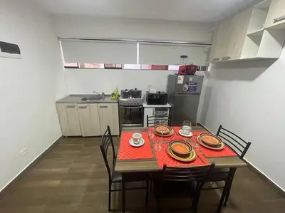 a small kitchen with a table and chairs and a kitchen with a table and chairs at (26) Departamento cómodo y tranquilo en Miraflores in Lima