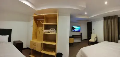 a hotel room with two beds and a desk at LA TERRAZA INN in Huancavelica
