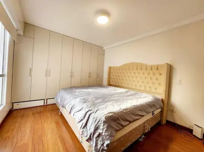 a bedroom with a large bed with white cabinets at R&M Apartament in Lima