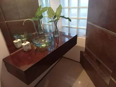 a wooden table with a glass bowl with a plant on it at Amplio, cómodo y moderno apartamento cerca al Mall in Lima