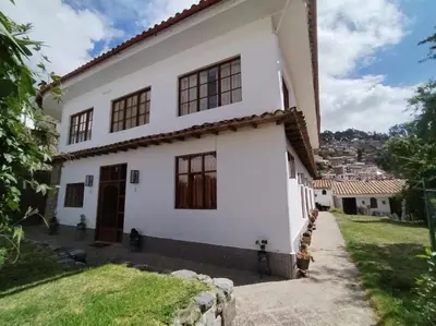 a white house with a view of the city at El Jardín de Jeni in Cusco