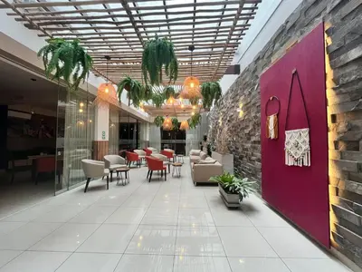 a lobby of a restaurant with tables and chairs at Hotel El Tambo 2 in Lima