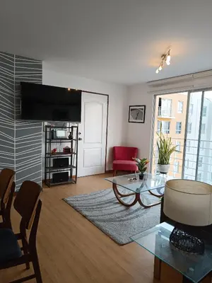 a living room with a couch and a table at Runawasi Apartments - Amaru 3BDR in Lima