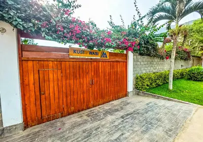 a wooden garage door with a sign on it at KUSI WASI CIENEGUILLA in Cieneguilla