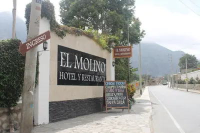 a sign for el mongino on the side of a street at El Molino Hotel y Restaurant in Lunahuaná