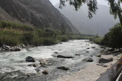a river with rocks on the side of a mountain at El Molino Hotel y Restaurant in Lunahuaná