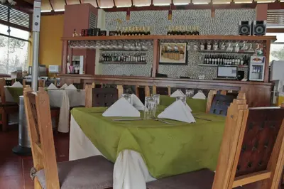 a restaurant with a table with a green table cloth at Lunahuana River Resort in Lunahuaná