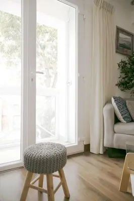 a living room with a chair and a window at Barranco Best Location - Apartment wAC in Lima