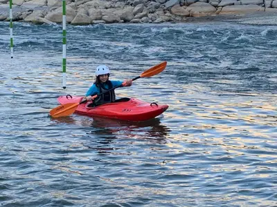 a person in a red kayak in the water at Refugio de Santiago Ecolodge in Lunahuaná
