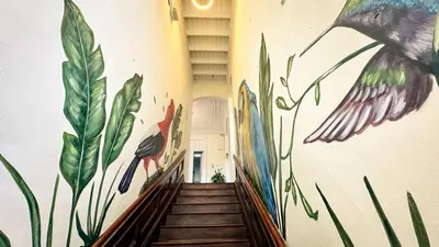 a hallway with a mural on the wall at Ancestral Hostel Barranco in Lima