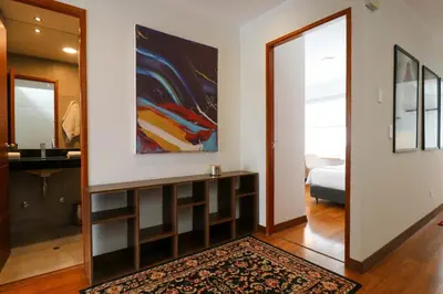 a hallway with a room with a mirror and a bedroom at Mimosas 145 by Wynwood House in Lima
