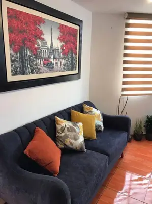 a blue couch with pillows on it in a living room at Hermoso Duplex en Chorrillos in Lima