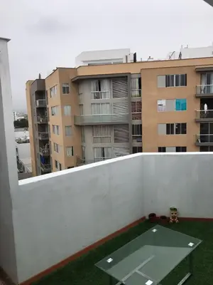 a balcony with a table and a building at Hermoso Duplex en Chorrillos in Lima