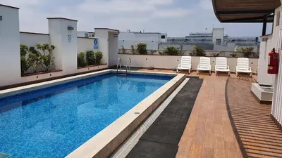 a swimming pool on the roof of a building at Hermoso departamento amoblado con piscina, area parrillas in Lima