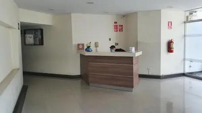 a woman sitting at a counter in a hospital room at Hermoso departamento amoblado con piscina, area parrillas in Lima