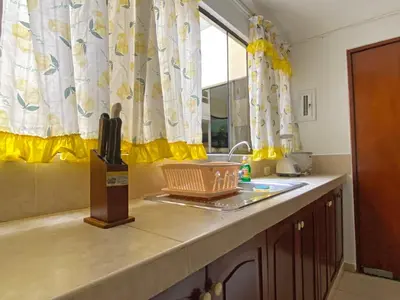 a kitchen counter with a sink and a window at Cómodo, céntrico, cerca a Parque Media Luna in Lima