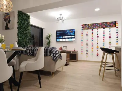 a living room with a dining room table and a television at Runawasi Apartments - Killary Miraflores 2BDR in Lima