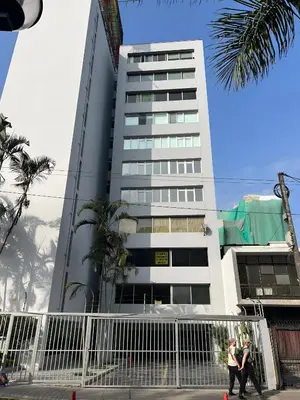 two people walking in front of a building at Bright 1BR close to boulevard in Lima