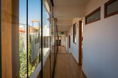 a corridor of a house with glass doors and a hallway at Inkantari Boutique Hotel in Cusco