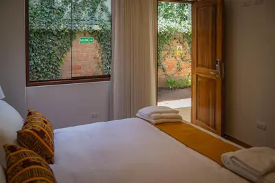 a bedroom with a bed with towels on it and a window at Inkantari Boutique Hotel in Cusco