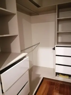 a closet with white cabinets and a wooden floor at EL PRAT Luxury Aparment Lima Peru in Lima