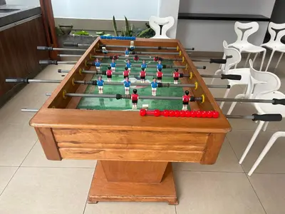 a wooden table with a pool table with at Alojamiento centrico acogedor con piscina cerca a Lima Historico in Lima