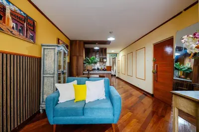 a blue couch with two yellow pillows in a hallway at Lima Virreinal & primer piso muy acogedor in Lima