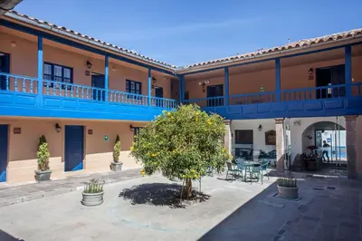 a large building with a tree in the courtyard at Tierra Viva Cusco San Blas in Cusco