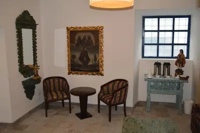 a room with two chairs and a table and a picture on the wall at Tierra Viva Cusco San Blas in Cusco