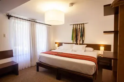 a bedroom with a large bed and a large window at Tierra Viva Cusco San Blas in Cusco