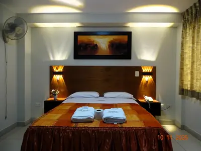 a bedroom with a bed with two towels on it at Hospedaje Dimar Inn in Lima