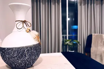 a black and white vase sitting on a table at Loft céntrico San borja - San Isidro in Lima