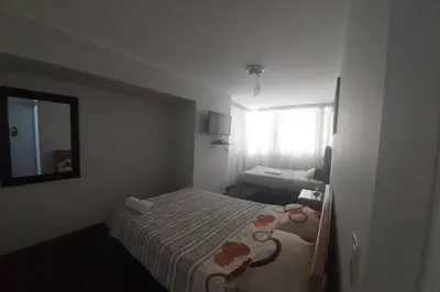 a hotel room with a bed and a mirror at APARTAMENTO 502 in Lima