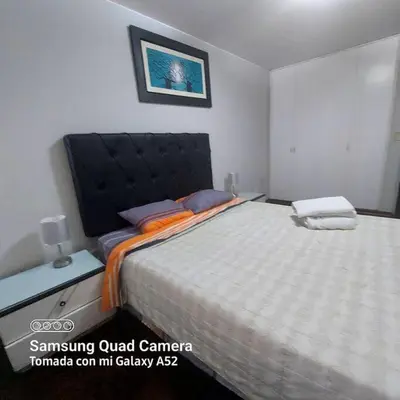a bedroom with a large bed with a black head board at APARTAMENTO 502 in Lima