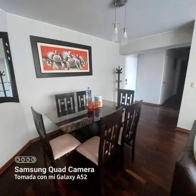 a dining room with a dining table and chairs at APARTAMENTO 502 in Lima