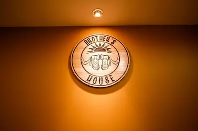 a light on a wall with a medal on it at BROTHERs HOUSE II in Cusco