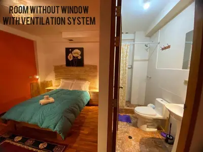a room with a bed and a bathroom with a toilet at BROTHERs HOUSE II in Cusco