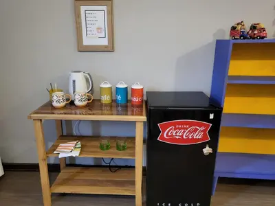 a table with a cocacola sign on it next to a small refrigerator at Alojamiento San Francisco - Apartamentos y habitaciones in Lima