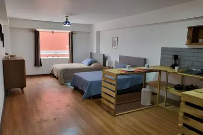a bedroom with a bed and a desk with a desk at Alojamiento San Francisco - Apartamentos y habitaciones in Lima