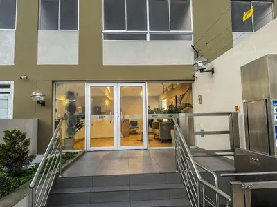 a staircase leading to a building with glass doors at Exclusivo con vista panorámica al mar - Ocean View in Lima