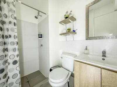 a white bathroom with a toilet and a sink at Exclusivo con vista panorámica al mar - Ocean View in Lima