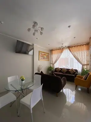 a living room with a couch and a glass table at LA FAMILIA NASCA HOUSE in Nazca
