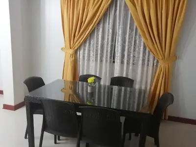 a dining room table with black chairs and a curtain at LA FAMILIA NASCA HOUSE in Nazca