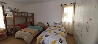 a bedroom with two beds and a bunk bed at Las buganvilias in Pachacamac