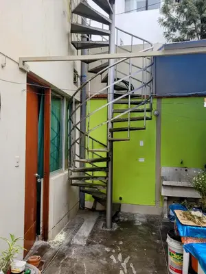 a building with a fire escape on the side of it at Habitación con baño propio para 2 personas como máximo in Lima