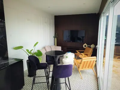 a living room with a table and chairs at Cozy 2BR Loft in the Heart of Miraflores in Lima